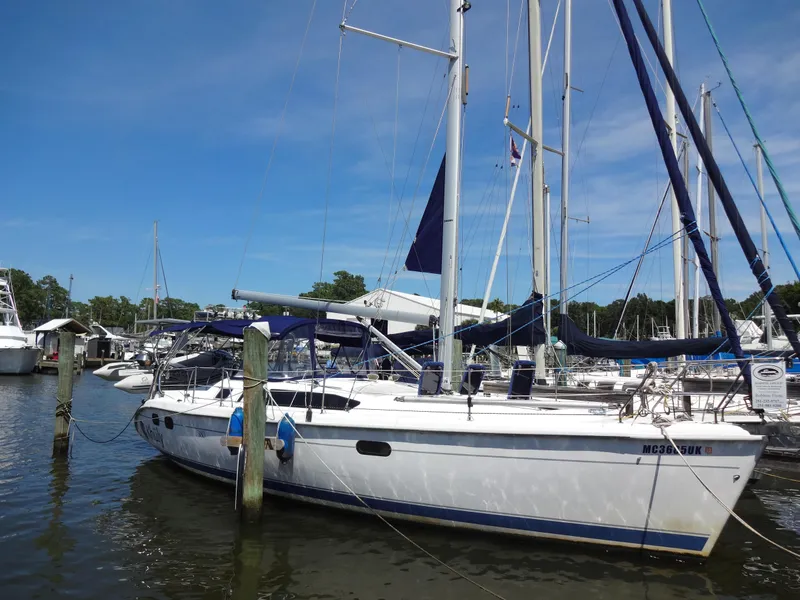 Slide: The Image of 2001 Hunter 380 sailboat docked at marina under clear blue sky. - 1