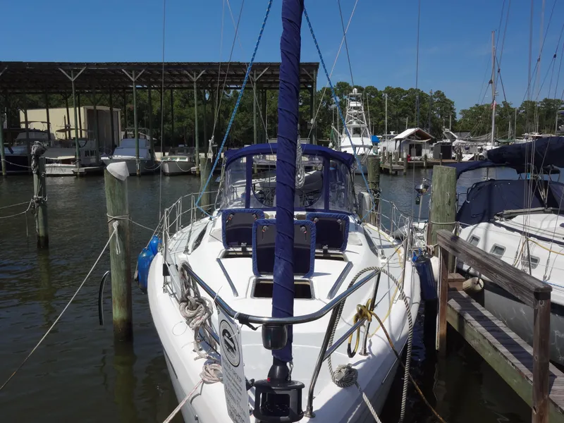 Slide: The Image of 2001 Hunter 380 sailboat docked at marina, surrounded by other boats. - 2