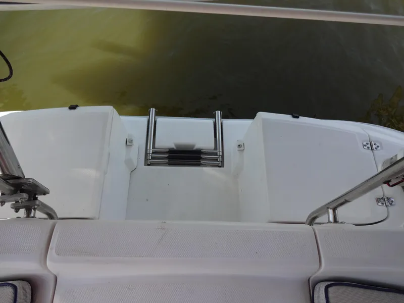 Slide: The Image of 2001 Hunter 380 boat swim platform with ladder, docked on calm water. - 21