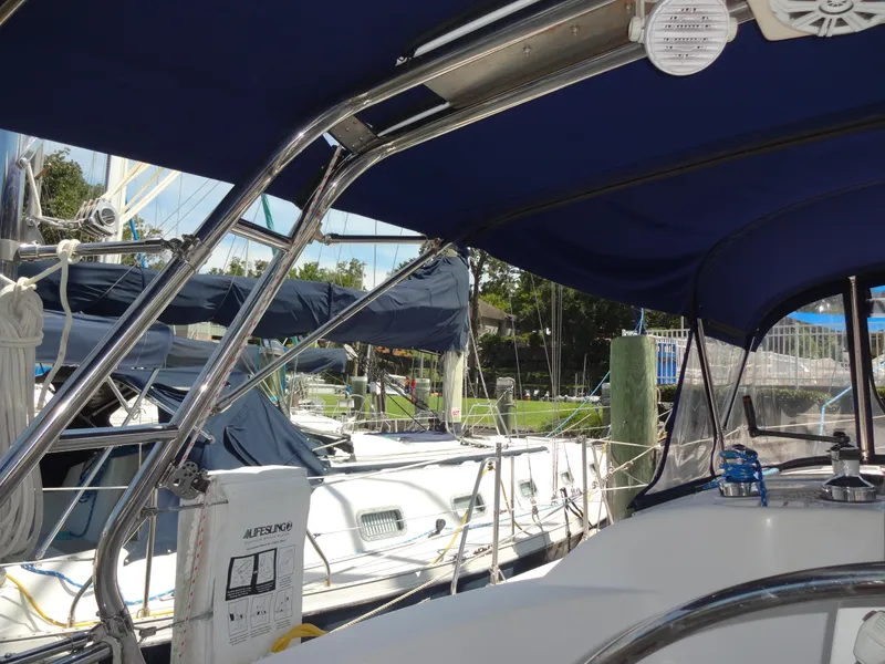 Slide: The Image of 2001 Hunter 380 sailboat docked with blue canopy and polished metal frame. - 22