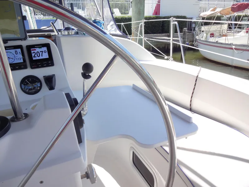 Slide: The Image of Hunter 380 sailboat cockpit with navigation instruments, steering wheel, and seating area, 2001 model. - 26