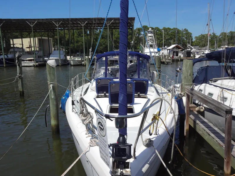 Slide: The Image of 2001 Hunter 380 sailboat docked at marina, surrounded by other boats. - 3
