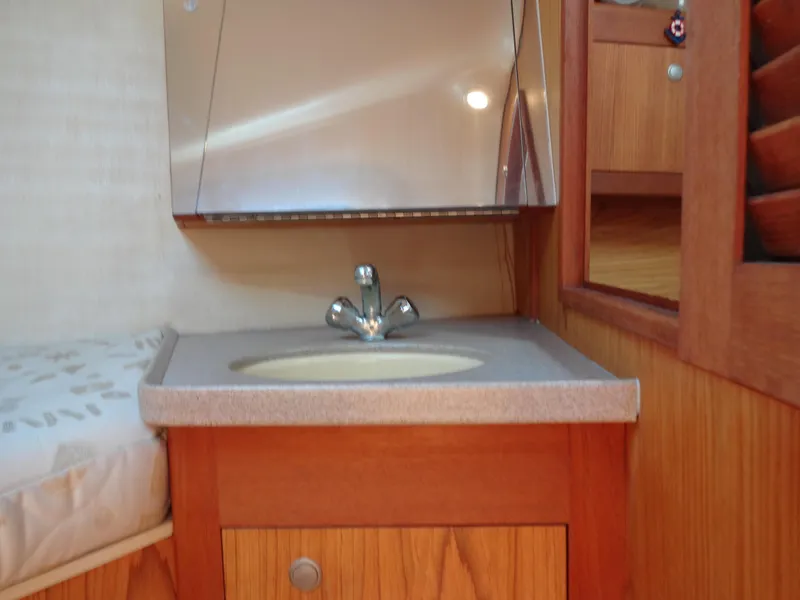 Slide: The Image of Wooden bathroom vanity with sink in 2001 Hunter 380 yacht. - 42