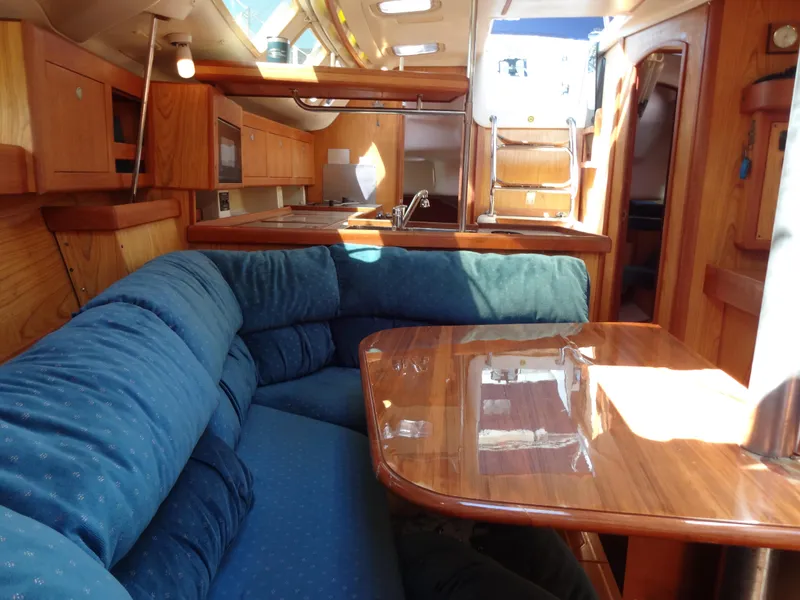 Slide: The Image of Interior of 2001 Hunter 380 sailboat with wood finish and blue upholstery. - 43