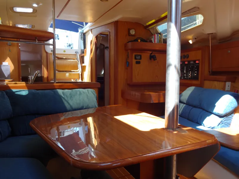Slide: The Image of Interior of 2001 Hunter 380 sailboat with wooden table and blue seating. - 46