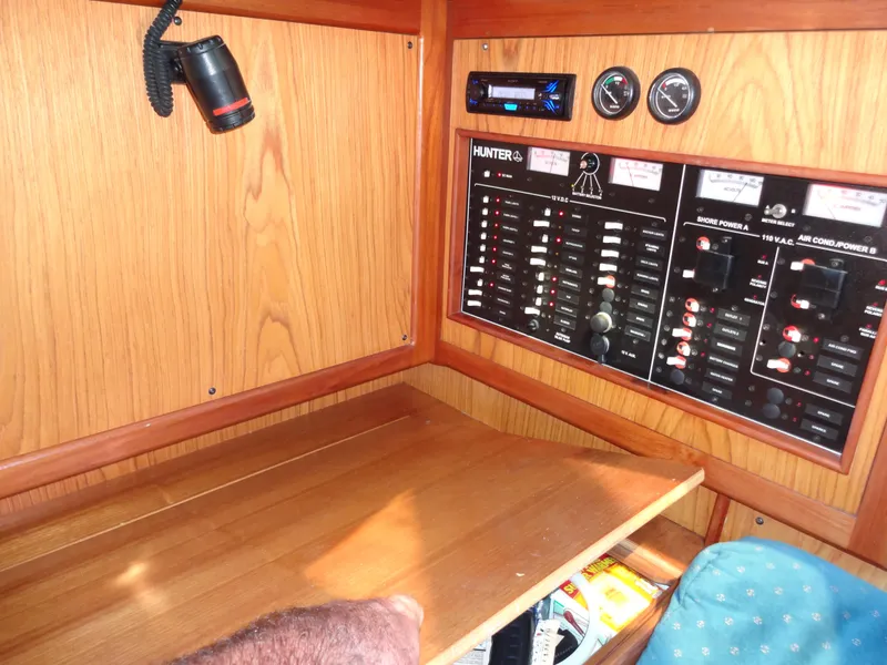 Slide: The Image of Control panel of a 2001 Hunter 380 sailboat with wood finish and gauges. - 49