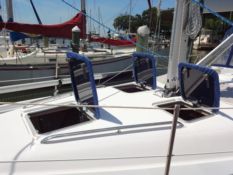 Slide: The Image of 2001 Hunter 380 sailboat with open hatches docked at marina. - 5