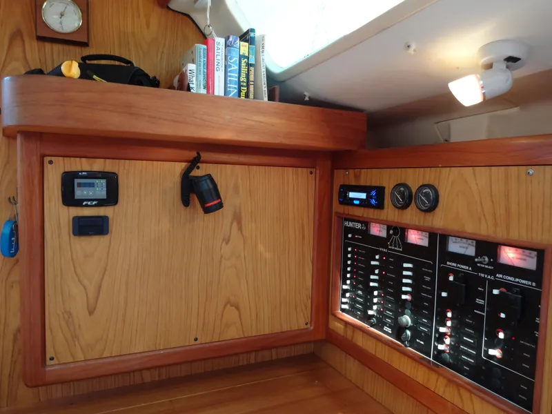 Slide: The Image of Interior of a 2001 Hunter 380 sailboat with control panels and navigation equipment. - 50