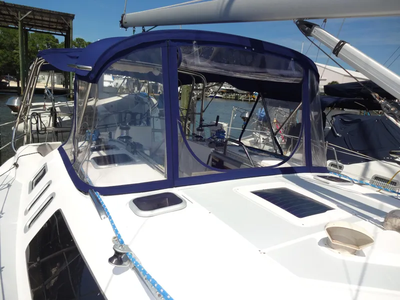 Slide: The Image of Sailboat Hunter 380, 2001 model, with blue canopy docked at marina. - 8