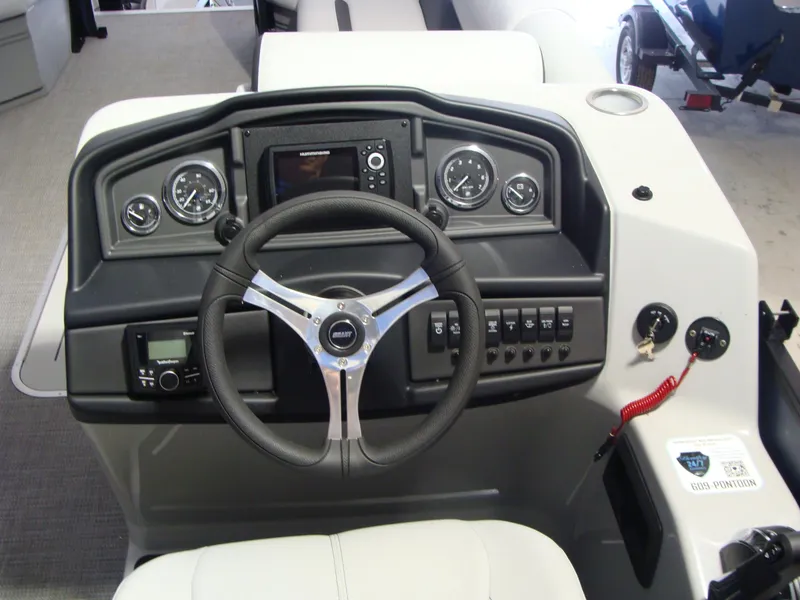 Slide: The Image of 2024 Bentley Pontoons 243 Swingback dashboard with steering wheel and control panel. - 5
