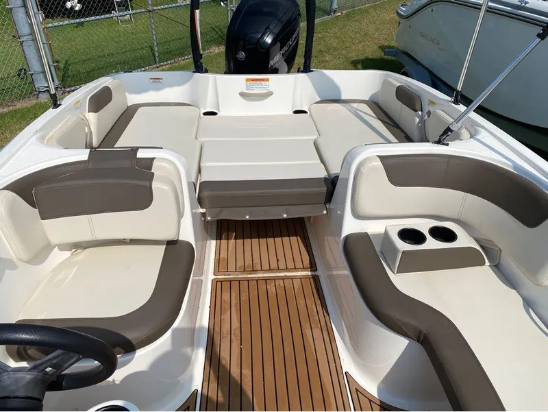 Slide: The Image of 2020 Bayliner Element E18 boat interior with spacious seating and cup holders. - 7