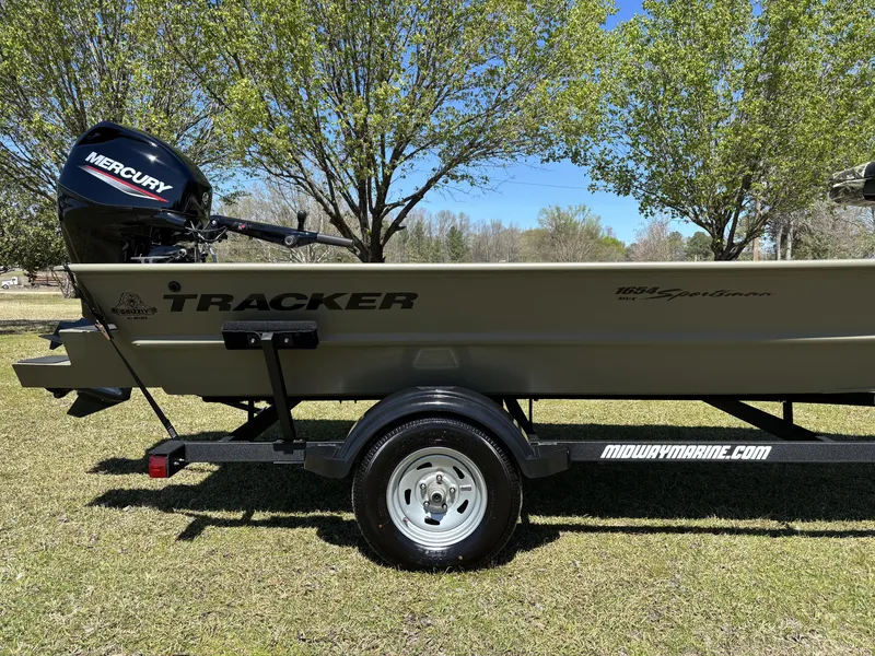 Slide: The Image of 2025 Tracker Grizzly 1654 T SportMan boat with Mercury engine on a trailer, outdoors. - 10