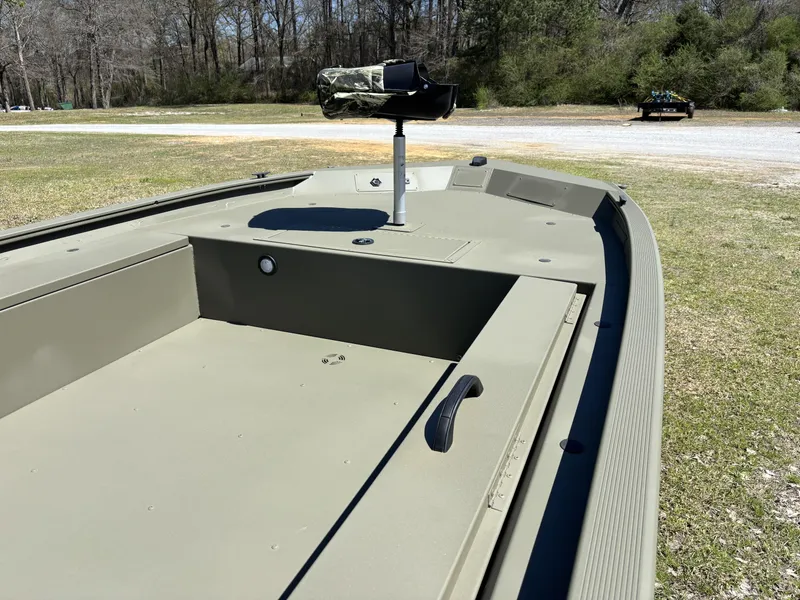 Slide: The Image of 2025 Tracker Grizzly 1654 T SportMan boat on grassy area, showcasing interior details. - 6