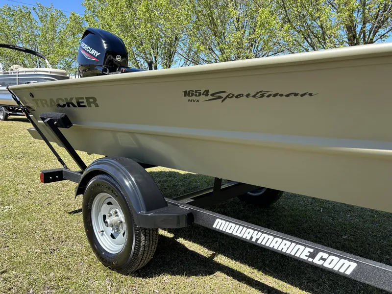 Slide: The Image of 2025 Tracker Grizzly 1654 T SportMan boat on trailer, featuring Mercury engine. - 9