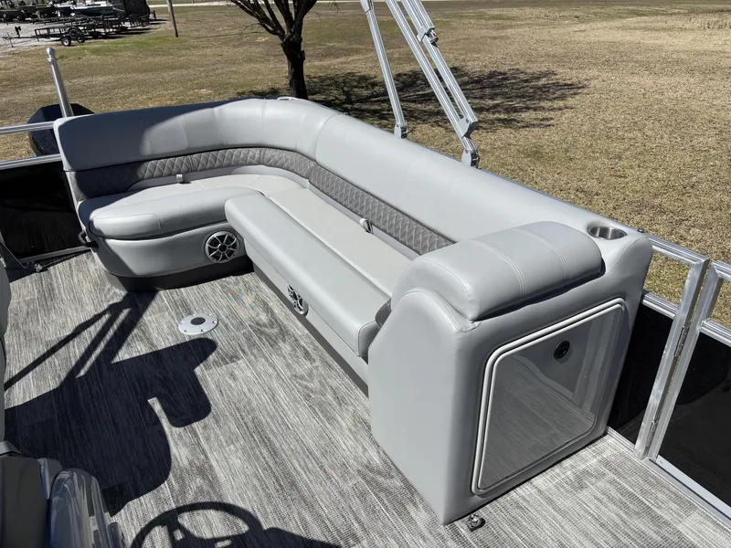 Slide: The Image of 2024 Ranger 223C pontoon boat with gray seating and spacious deck. - 12