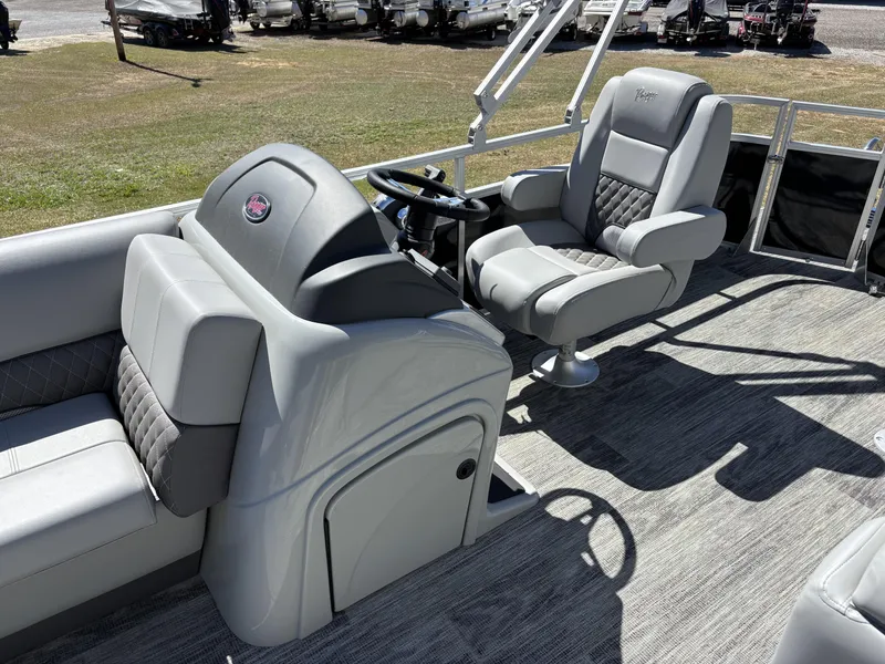 Slide: The Image of 2024 Ranger 223C boat interior with gray seating and steering console. - 6