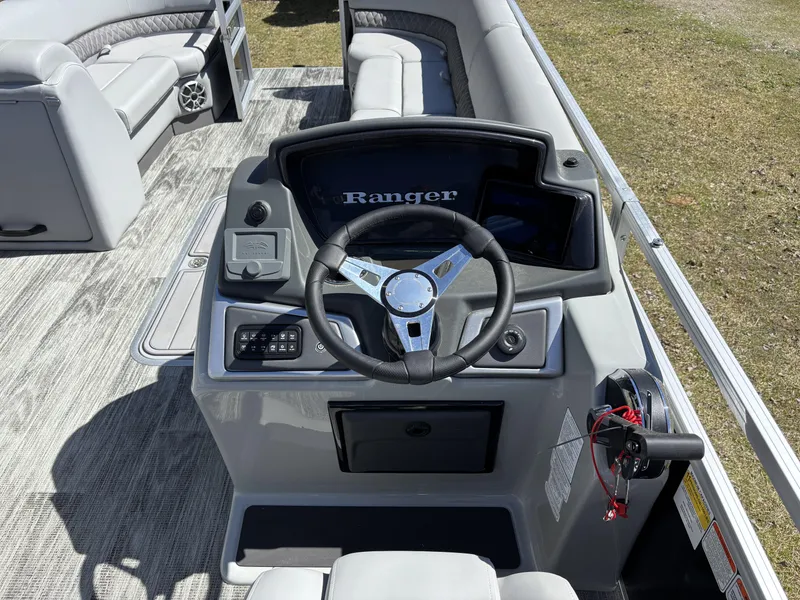 Slide: The Image of 2024 Ranger 223C boat interior with steering wheel and seating area. - 8
