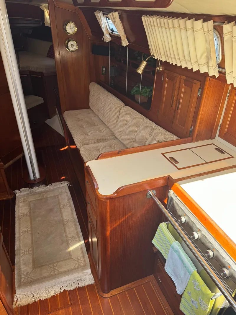 Slide: The Image of Interior of 1987 Ericson 35-3 sailboat with wood finish and cozy seating area. - 11