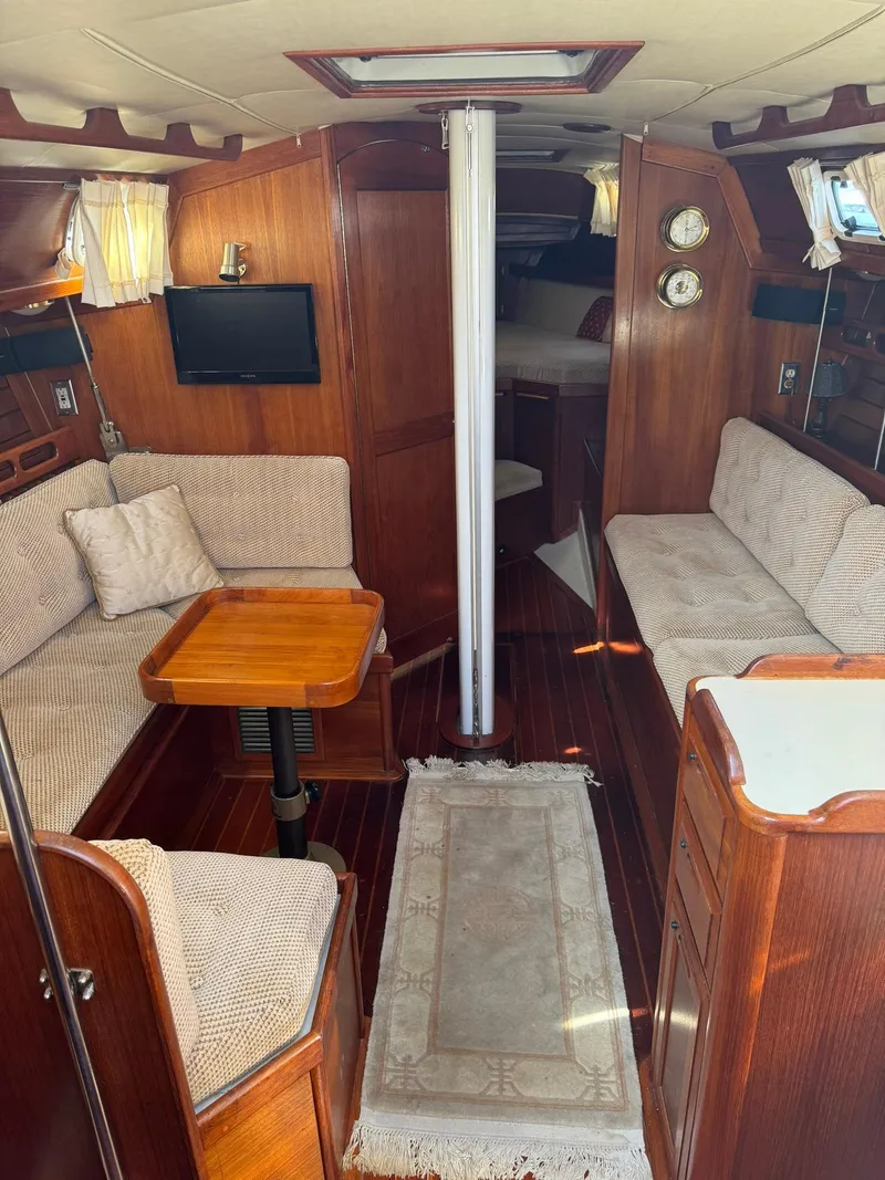 Slide: The Image of Interior of 1987 Ericson 35-3 sailboat with cozy seating and wooden finishes. - 12