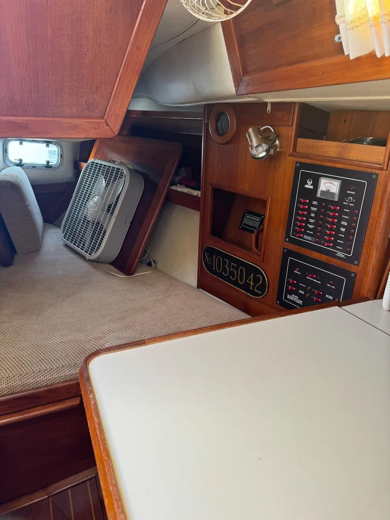 Slide: The Image of 1987 Ericson 35-3 yacht interior with control panels and fan. - 13