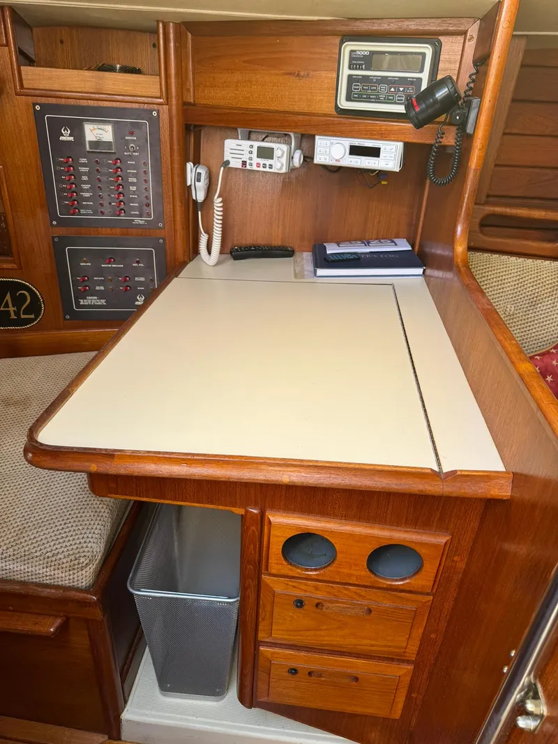 Slide: The Image of 1987 Ericson 35-3 yacht navigation station with radio and control panels. - 14