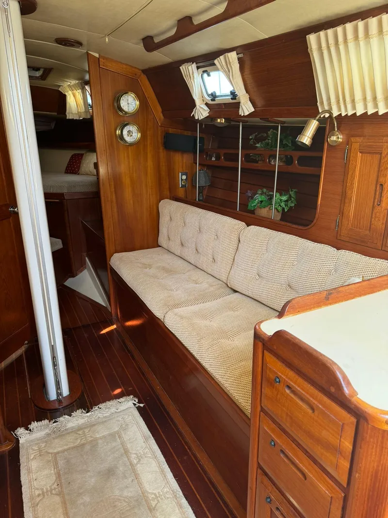 Slide: The Image of 1987 Ericson 35-3 sailboat interior with wood finish and cozy seating area. - 16