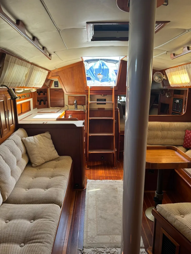 Slide: The Image of Interior of 1987 Ericson 35-3 sailboat with cozy seating and wooden finishes. - 19