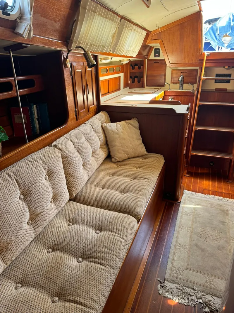Slide: The Image of Cozy interior of 1987 Ericson 35-3 sailboat with plush seating and wooden accents. - 20