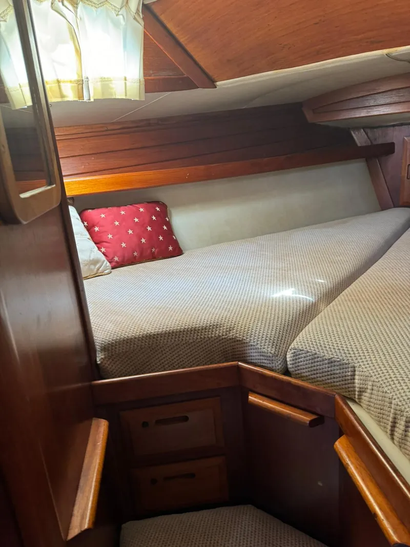 Slide: The Image of Cozy cabin interior of 1987 Ericson 35-3 sailboat with wooden finish and bedding. - 22