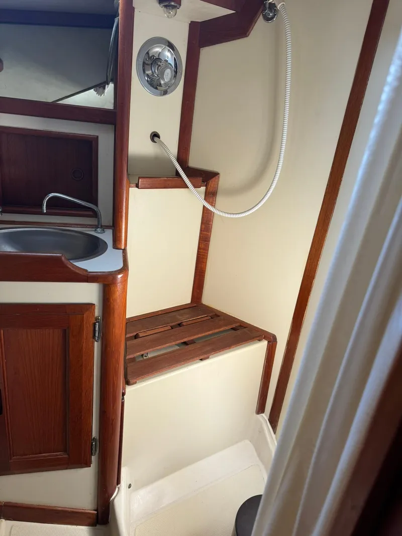 Slide: The Image of 1987 Ericson 35-3 yacht bathroom with wooden accents and shower. - 32