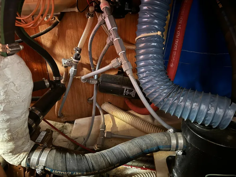 Slide: The Image of Engine compartment of a 1987 Ericson 35-3 sailboat with hoses and wiring. - 35