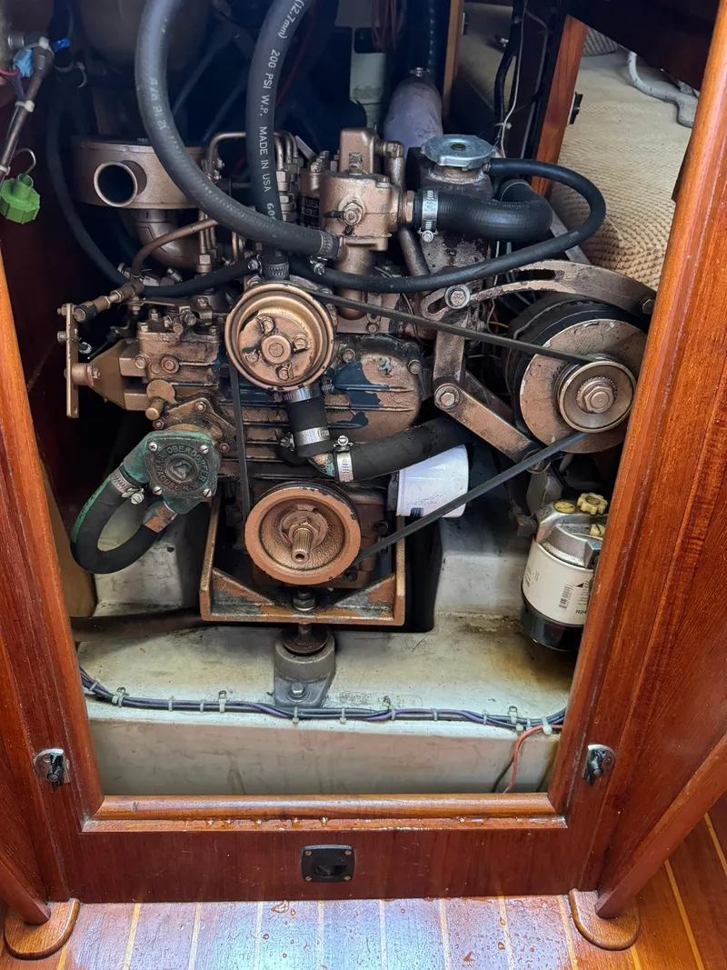 Slide: The Image of 1987 Ericson 35-3 sailboat engine compartment with visible components and belts. - 36