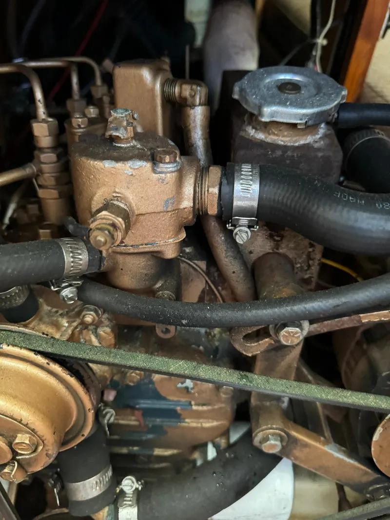 Slide: The Image of 1987 Ericson 35-3 engine close-up with hoses and metal components. - 39