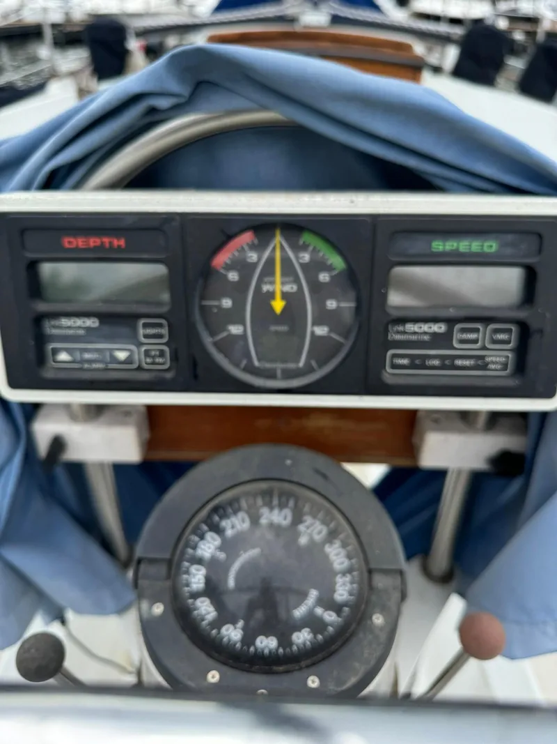 Slide: The Image of Ericson 35-3 1987 sailboat dashboard with depth, speed gauges, and compass. - 6