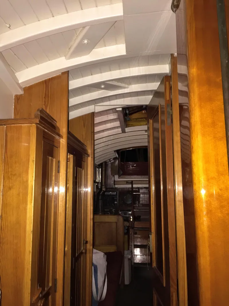 Slide: The Image of Interior of 1964 Concordia 41 Yawl, showcasing wooden cabinetry and classic nautical design. - 10