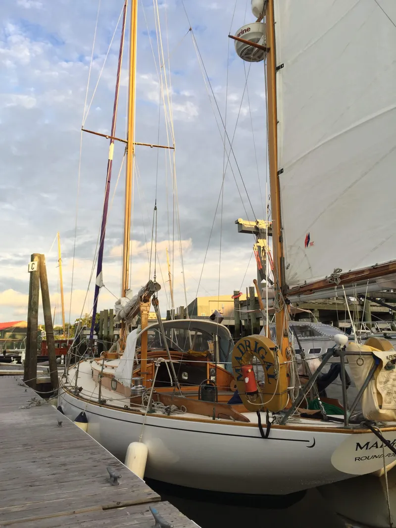 Slide: The Image of 1964 Concordia 41 Yawl docked at marina, showcasing classic wooden design. - 11