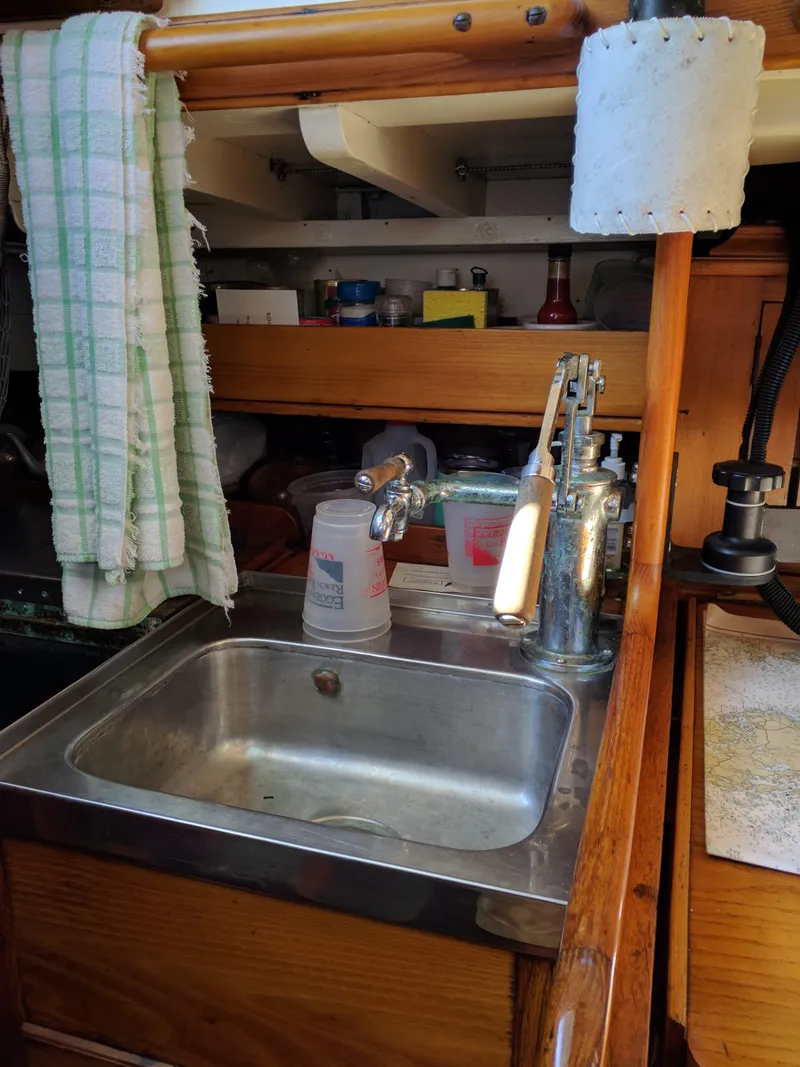 Slide: The Image of 1964 Concordia 41 Yawl galley with sink, towel, and kitchen essentials. - 13