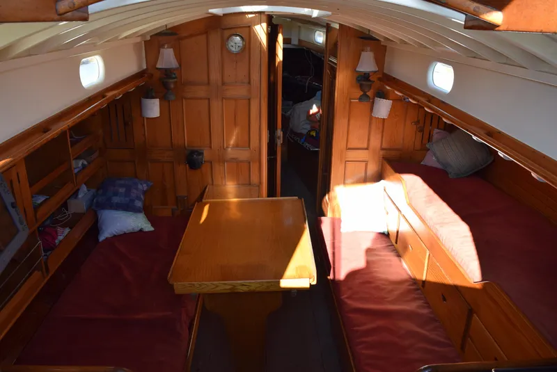 Slide: The Image of Interior of 1964 Concordia 41 Yawl, featuring wooden furnishings and cozy seating. - 17