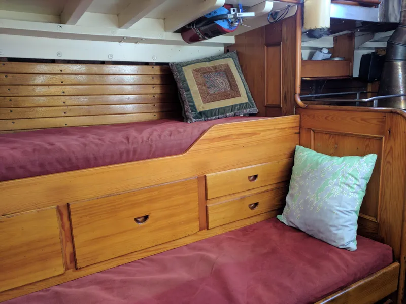 Slide: The Image of Interior of a 1964 Concordia 41 Yawl with wooden cabinetry and red cushions. - 20