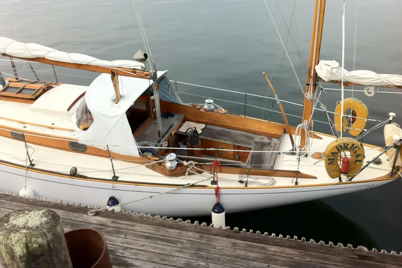 Slide: The Image of 1964 Concordia 41 Yawl docked, showcasing classic wooden design and elegant sails. - 23