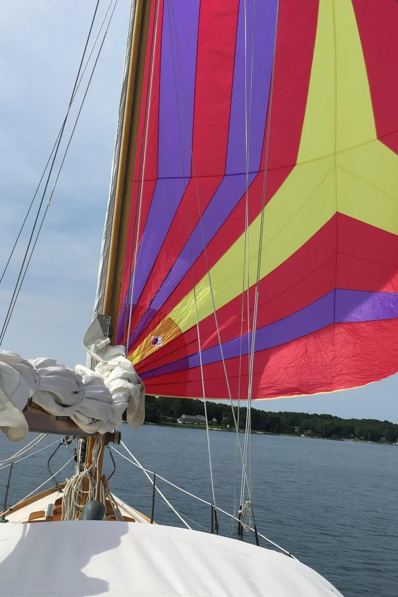 Slide: The Image of Colorful sails on a 1964 Concordia 41 Yawl sailing on calm waters. - 28