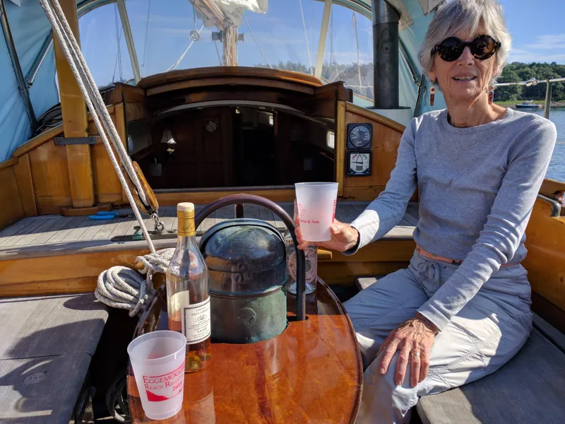Slide: The Image of Woman enjoying a drink on a 1964 Concordia 41 Yawl sailboat. - 3