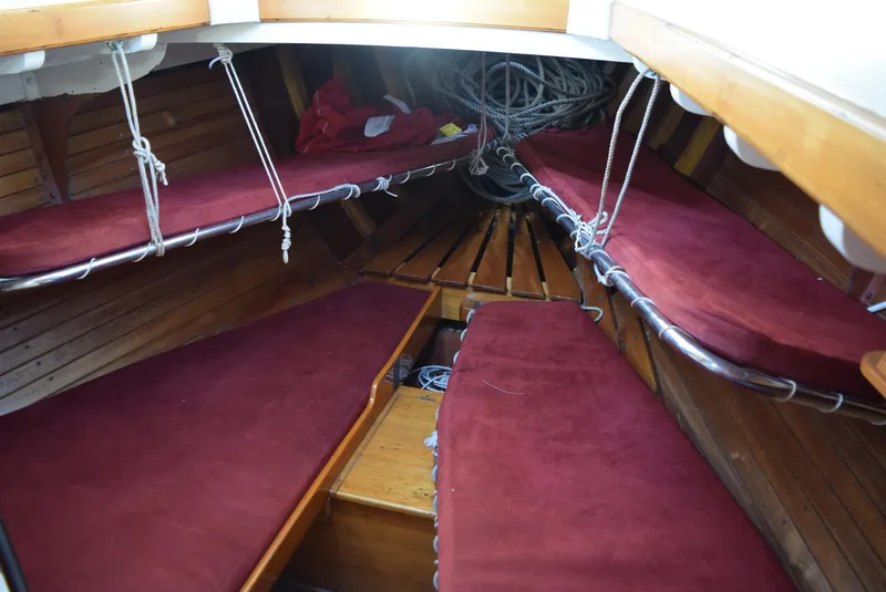 Slide: The Image of Interior of 1964 Concordia 41 Yawl with red cushions and wooden finish. - 9