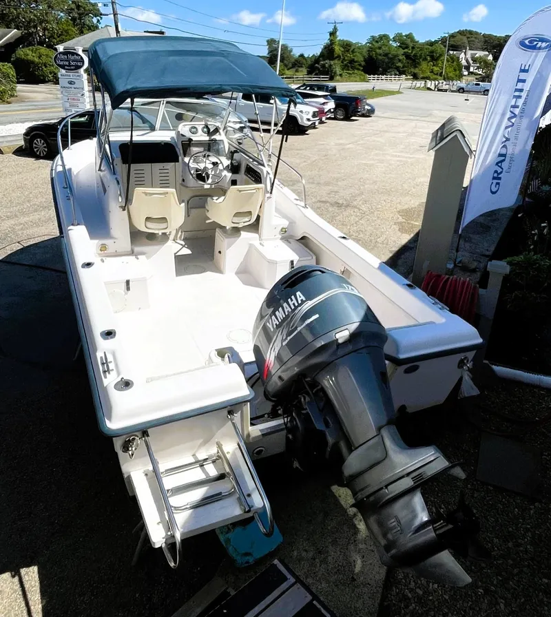 Slide: The Image of 2001 Grady-White Adventure 208 boat with Yamaha outboard motor, docked outdoors. - 10