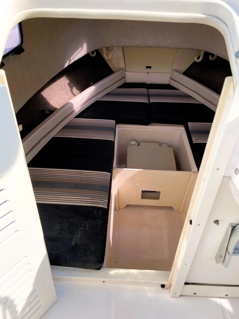 Slide: The Image of 2001 Grady-White Adventure 208 cabin interior with seating and storage. - 11