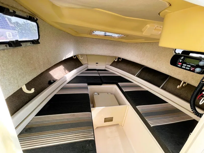 Slide: The Image of Interior cabin of 2001 Grady-White Adventure 208 boat with striped seating. - 12