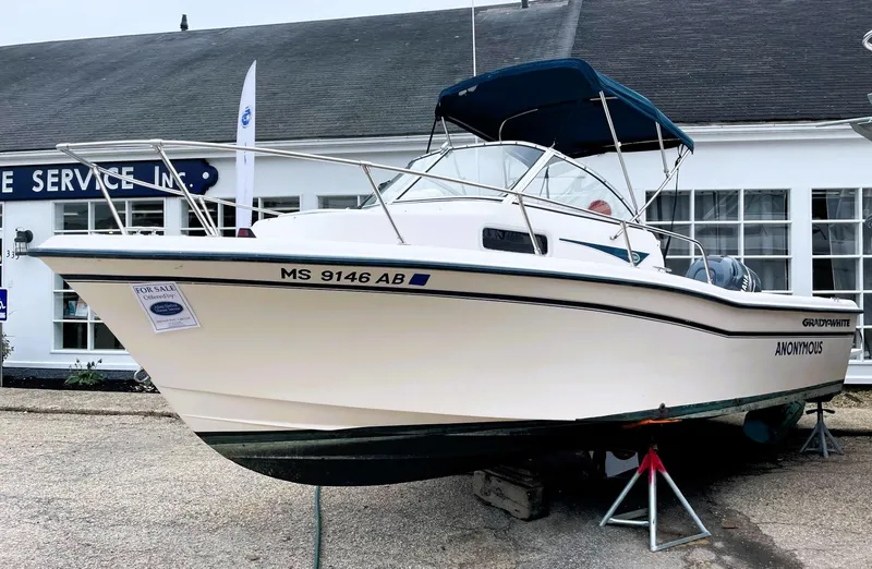 Slide: The Image of 2001 Grady-White Adventure 208 boat displayed outside a service center. - 2
