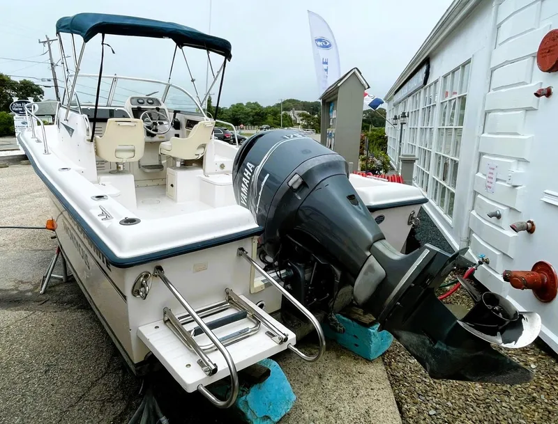 Slide: The Image of 2001 Grady-White Adventure 208 boat with Yamaha outboard motor, docked outdoors. - 4