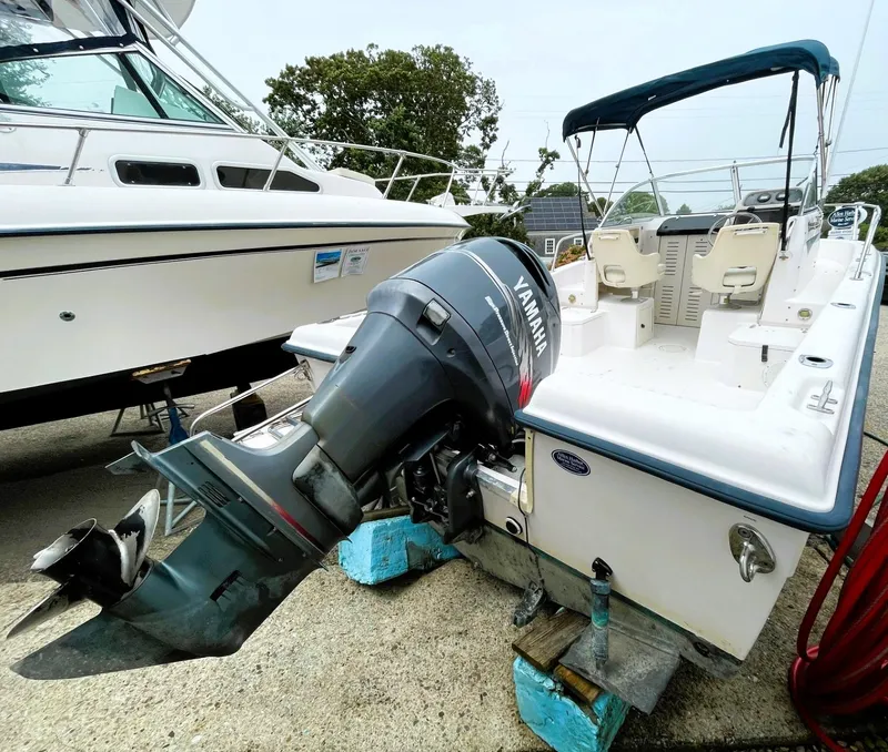 Slide: The Image of 2001 Grady-White Adventure 208 boat with Yamaha outboard motor, docked on land. - 5