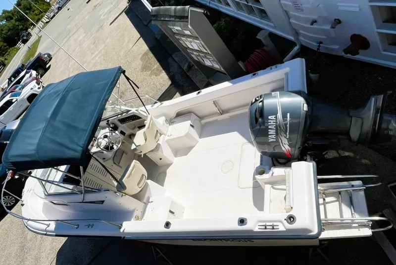 Slide: The Image of 2001 Grady-White Adventure 208 boat with Yamaha outboard motor, docked and ready for use. - 9